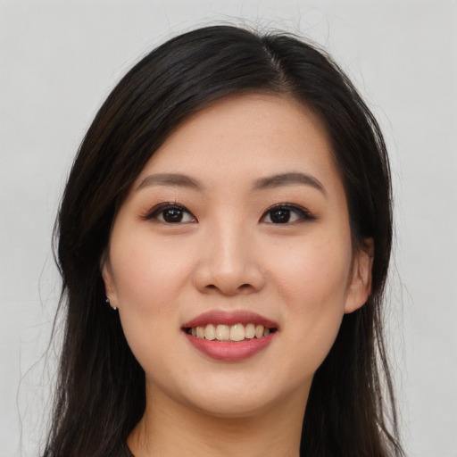 Joyful asian young-adult female with long  black hair and brown eyes