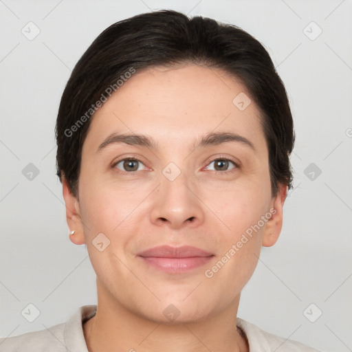 Joyful white young-adult female with short  brown hair and brown eyes