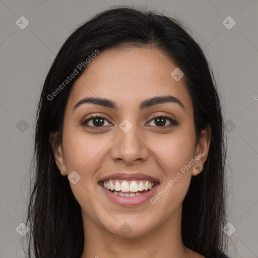 Joyful latino young-adult female with long  brown hair and brown eyes