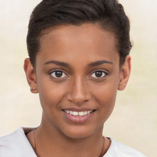 Joyful black young-adult female with short  brown hair and brown eyes