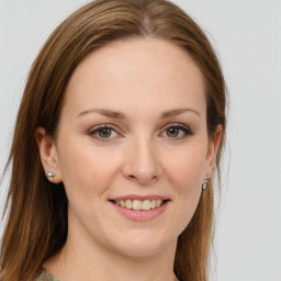 Joyful white young-adult female with medium  brown hair and green eyes