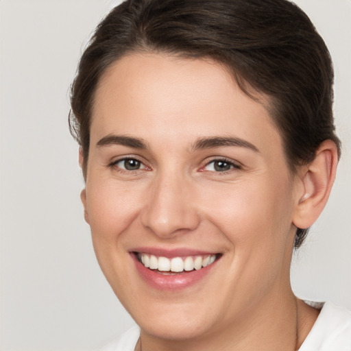 Joyful white young-adult female with medium  brown hair and brown eyes