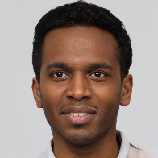Joyful black young-adult male with short  black hair and brown eyes