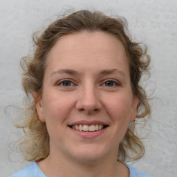 Joyful white young-adult female with medium  brown hair and blue eyes