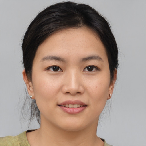 Joyful asian young-adult female with medium  brown hair and brown eyes