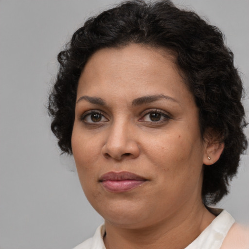 Joyful latino adult female with short  brown hair and brown eyes