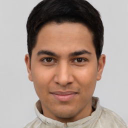 Joyful latino young-adult male with short  brown hair and brown eyes