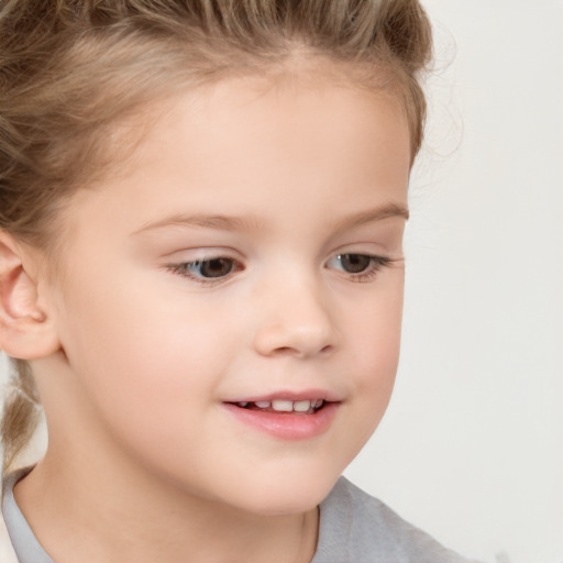 Joyful white child female with short  brown hair and brown eyes