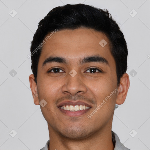 Joyful latino young-adult male with short  black hair and brown eyes