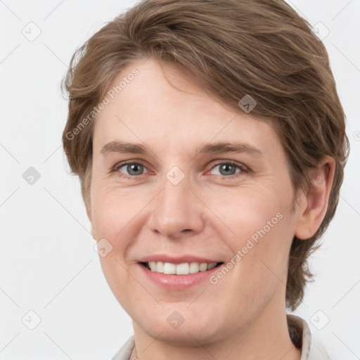 Joyful white young-adult female with short  brown hair and grey eyes