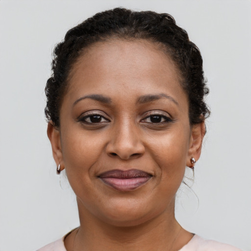 Joyful black young-adult female with short  brown hair and brown eyes