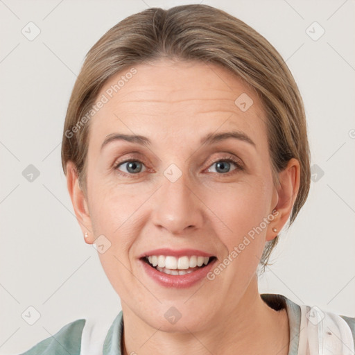 Joyful white adult female with short  brown hair and grey eyes