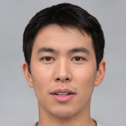 Joyful asian young-adult male with short  black hair and brown eyes