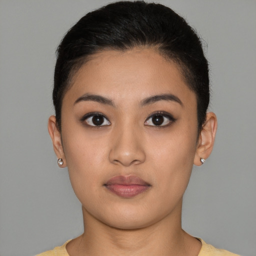 Joyful latino young-adult female with short  brown hair and brown eyes