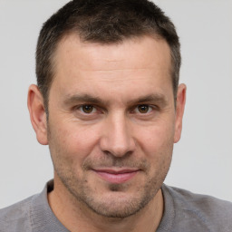 Joyful white adult male with short  brown hair and brown eyes