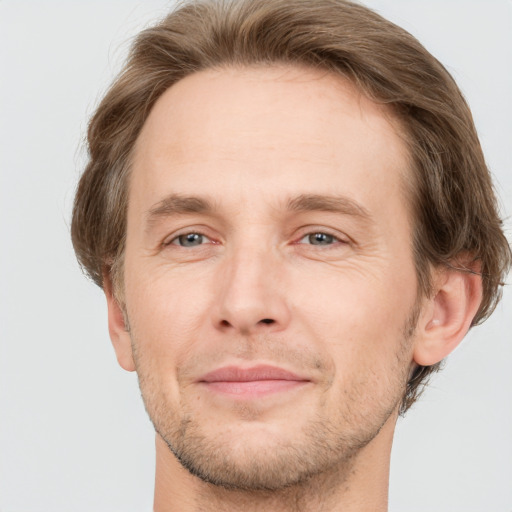 Joyful white adult male with short  brown hair and grey eyes