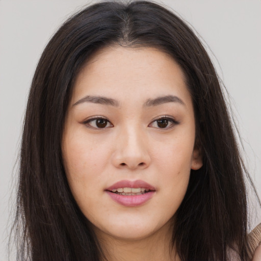 Joyful asian young-adult female with long  brown hair and brown eyes