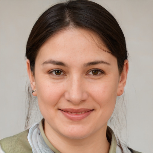 Joyful white young-adult female with medium  brown hair and brown eyes