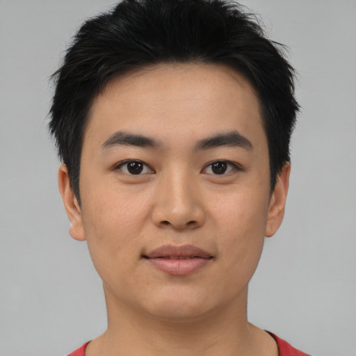 Joyful asian young-adult male with short  black hair and brown eyes