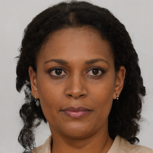 Neutral black young-adult female with long  brown hair and brown eyes