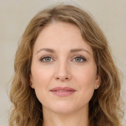 Joyful white young-adult female with long  brown hair and green eyes