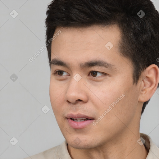 Joyful white young-adult male with short  black hair and brown eyes