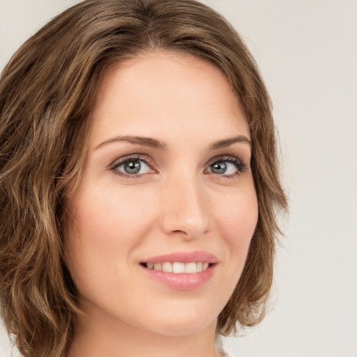 Joyful white young-adult female with medium  brown hair and green eyes