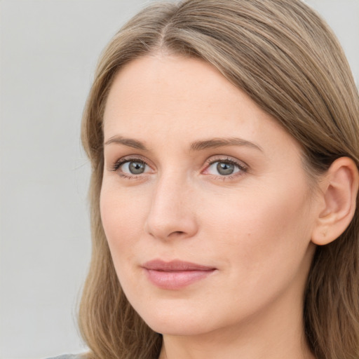 Joyful white young-adult female with long  brown hair and blue eyes