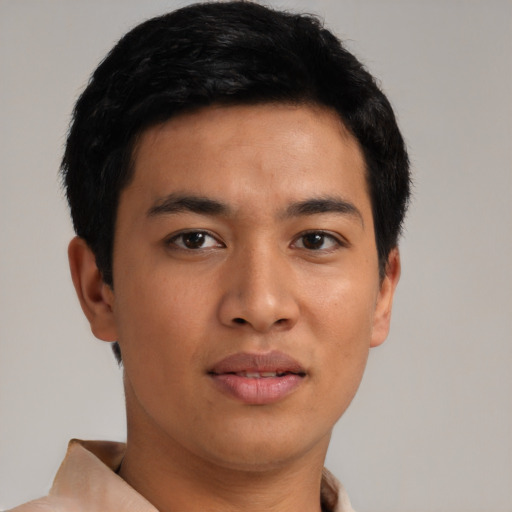 Joyful asian young-adult male with short  black hair and brown eyes