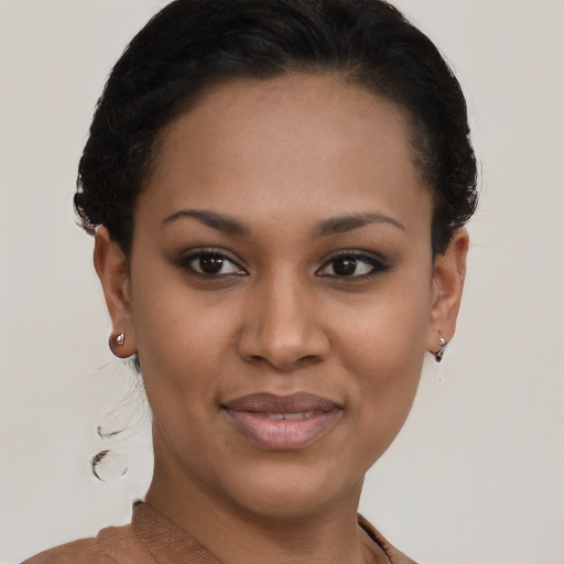 Joyful black young-adult female with short  brown hair and brown eyes
