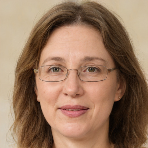 Joyful white adult female with long  brown hair and green eyes