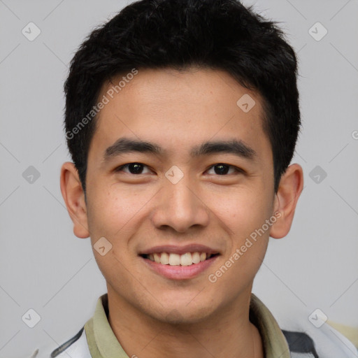 Joyful white young-adult male with short  black hair and brown eyes