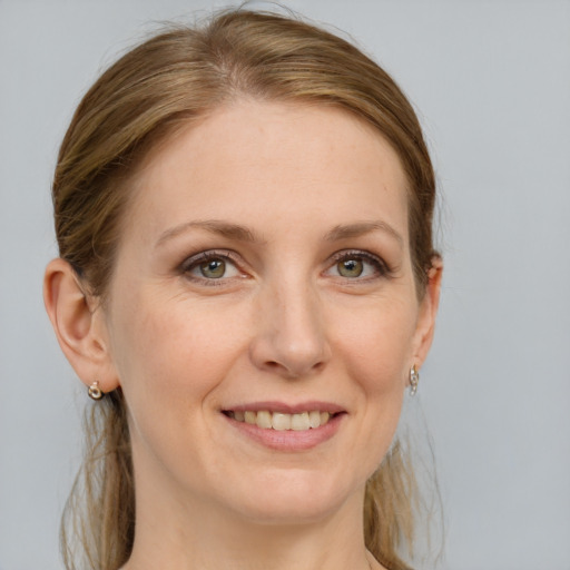 Joyful white adult female with medium  brown hair and grey eyes