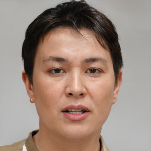 Joyful white adult female with short  brown hair and brown eyes