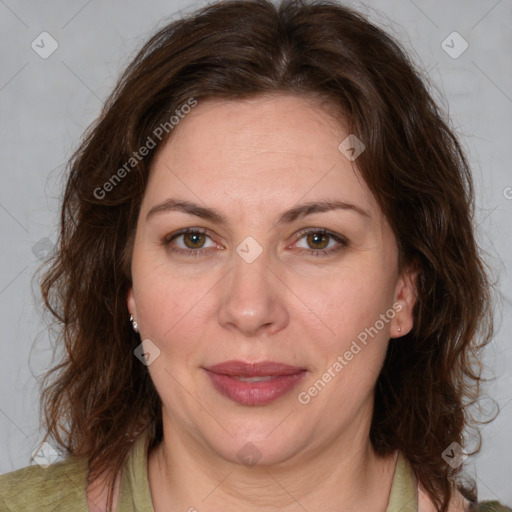 Joyful white adult female with medium  brown hair and green eyes