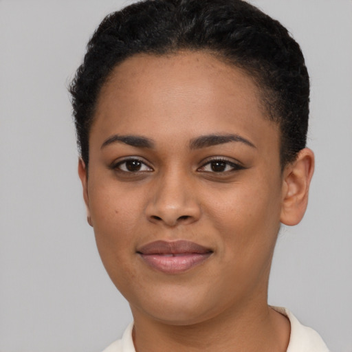 Joyful black young-adult female with short  brown hair and brown eyes