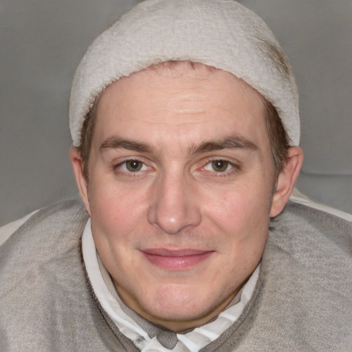 Joyful white adult male with short  brown hair and blue eyes