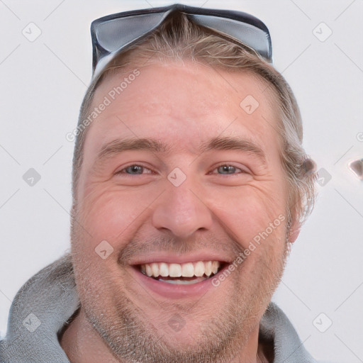 Joyful white adult male with short  brown hair and grey eyes