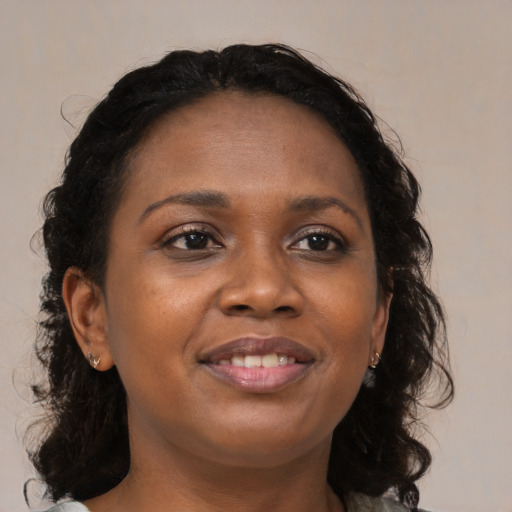 Joyful black young-adult female with medium  brown hair and brown eyes