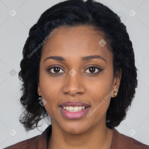 Joyful black young-adult female with long  black hair and brown eyes