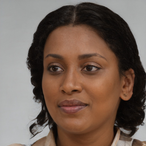 Joyful black young-adult female with medium  brown hair and brown eyes