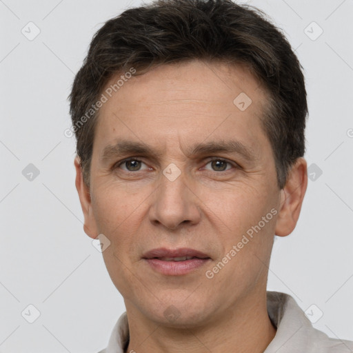 Joyful white adult male with short  brown hair and brown eyes