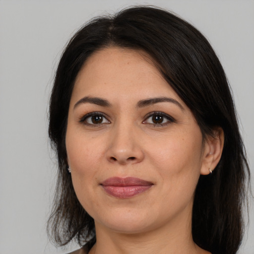 Joyful latino young-adult female with medium  brown hair and brown eyes