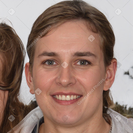 Joyful white adult female with medium  brown hair and grey eyes