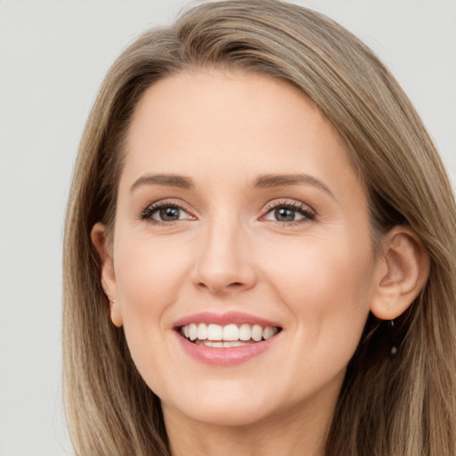 Joyful white young-adult female with long  brown hair and brown eyes