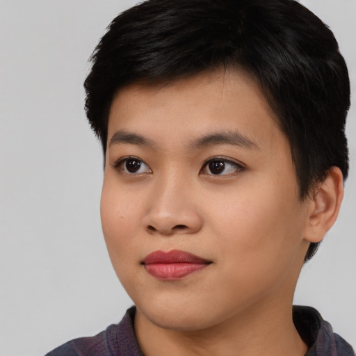 Joyful asian young-adult female with short  black hair and brown eyes