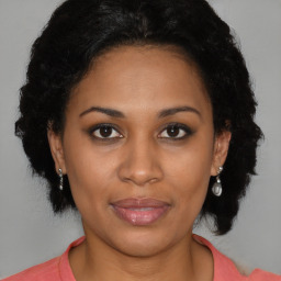 Joyful black adult female with medium  black hair and brown eyes