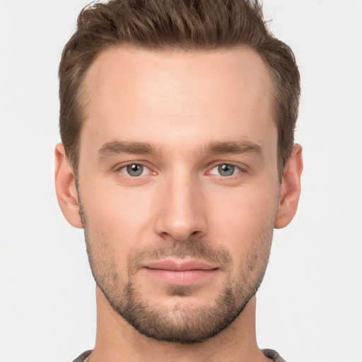 Joyful white young-adult male with short  brown hair and grey eyes