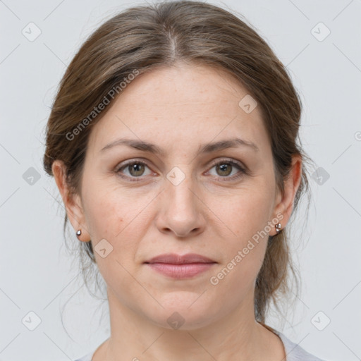 Joyful white adult female with medium  brown hair and grey eyes