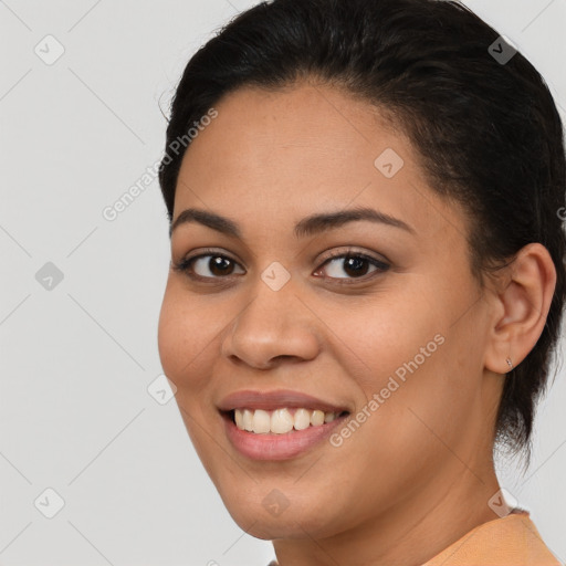 Joyful latino young-adult female with medium  brown hair and brown eyes